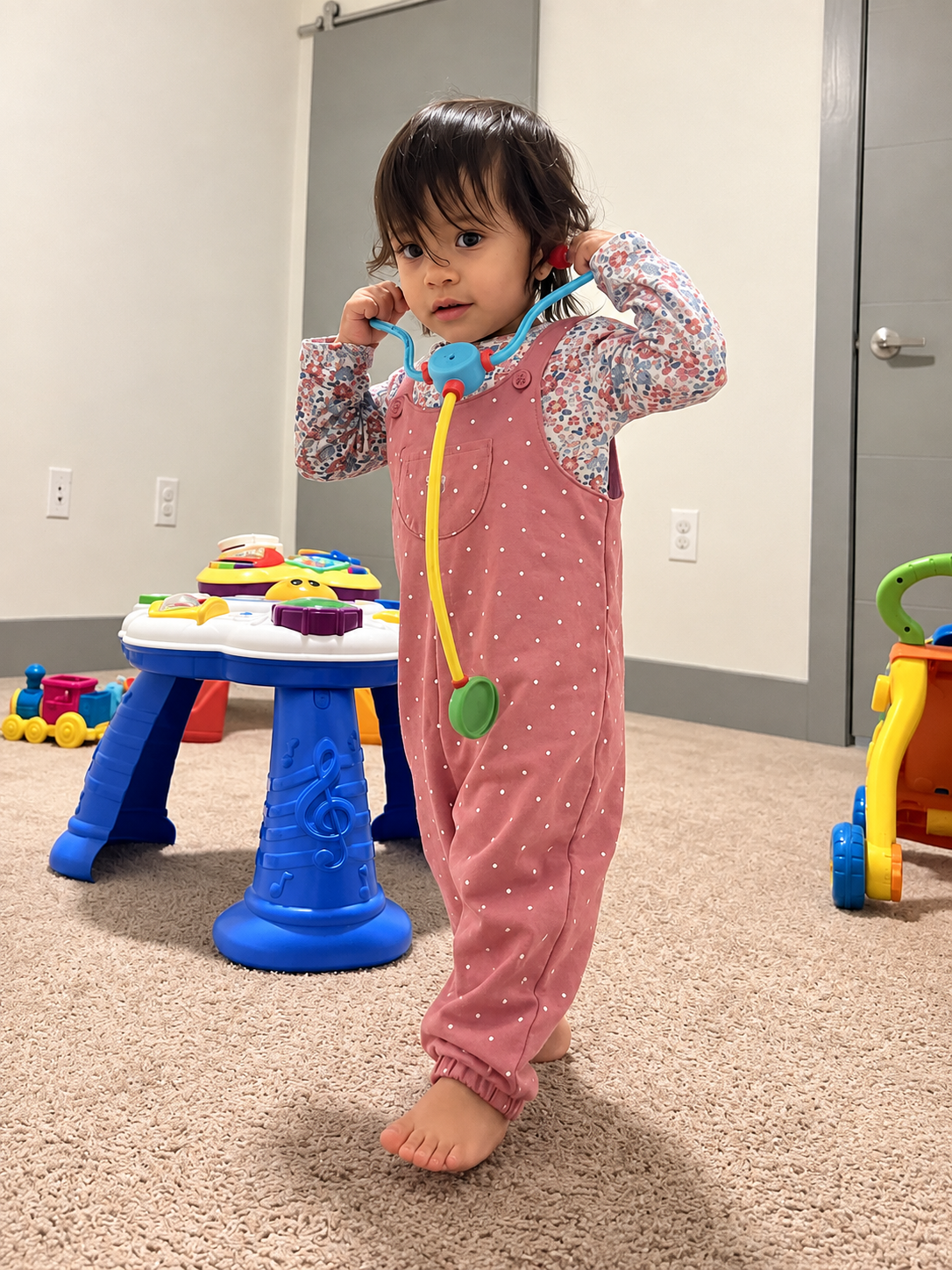 Aria playing doctor with her toy stethoscope